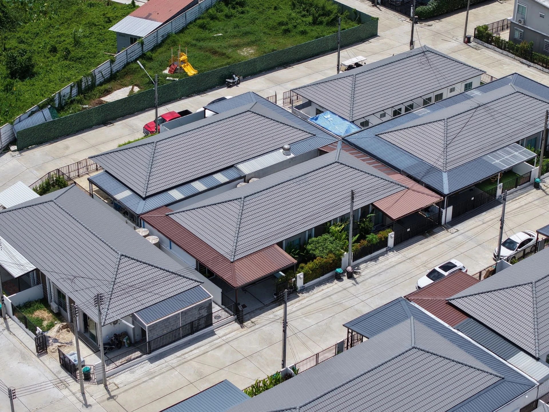 Aerial view of residential complex architecture with metal roofing, Thalang
