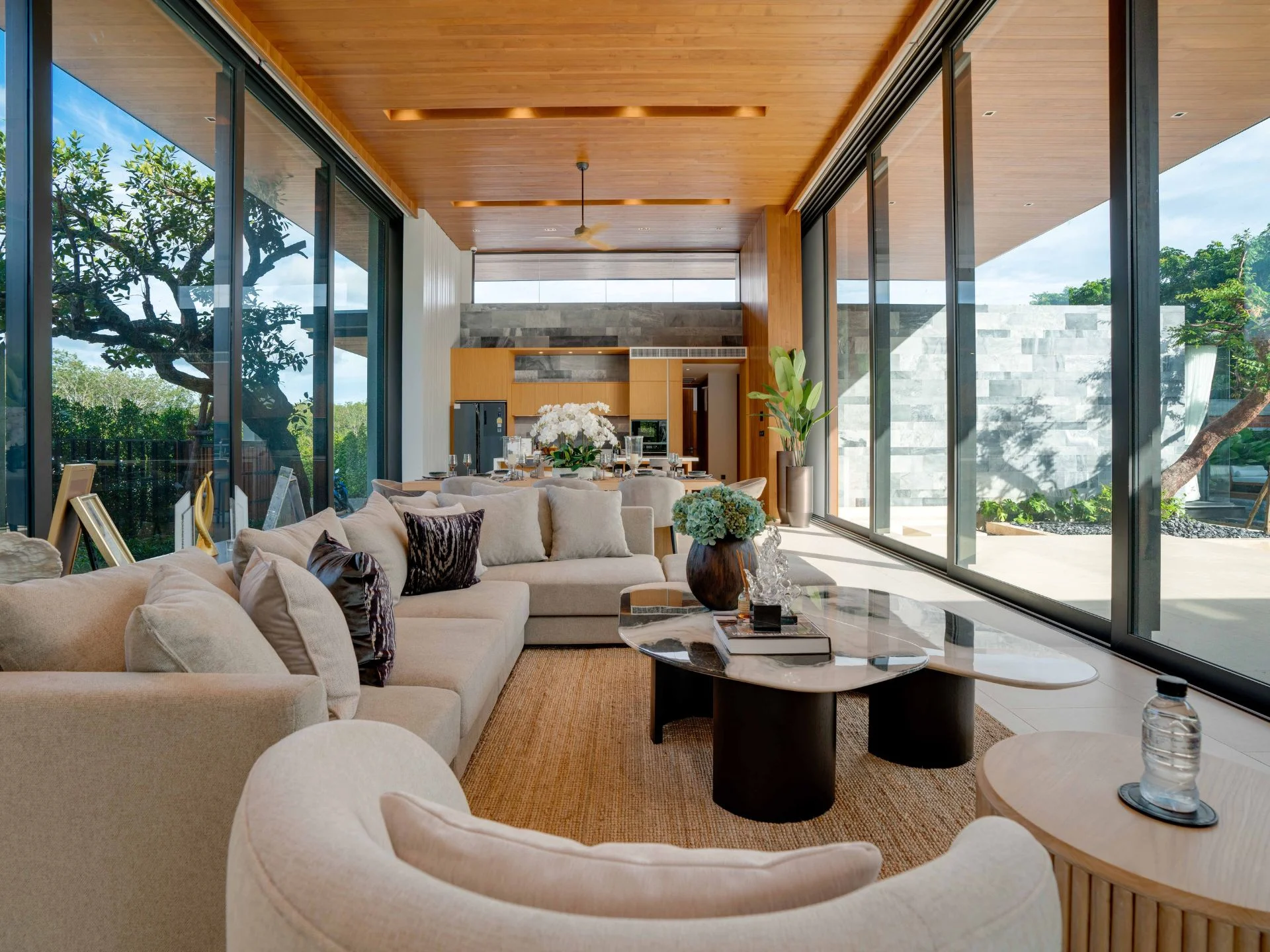 Living room interior with open-plan kitchen in a luxury apartment at Botanica Majestia, Thailand