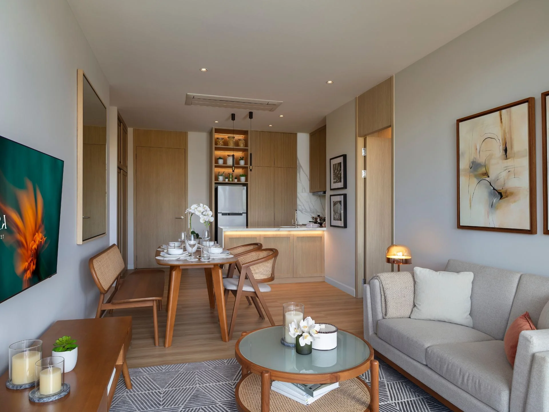 Open-plan living and dining area with kitchen in 1-bedroom apartment at SUDARA, Thailand