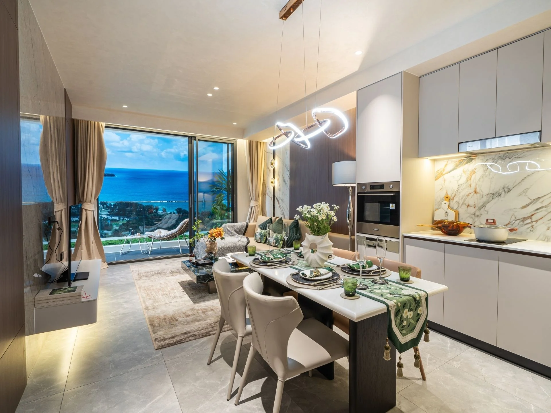 Open-plan kitchen and dining area with sea view in 2-bedroom apartment at AYANA Heights, Bang Tao