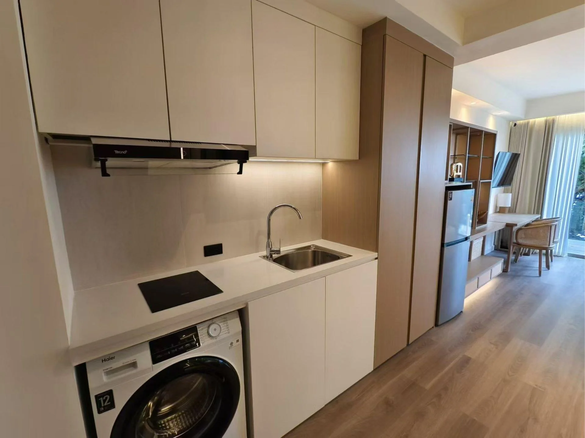 Kitchen interior with washing machine in studio apartment at Anava Samui, Bo Pu