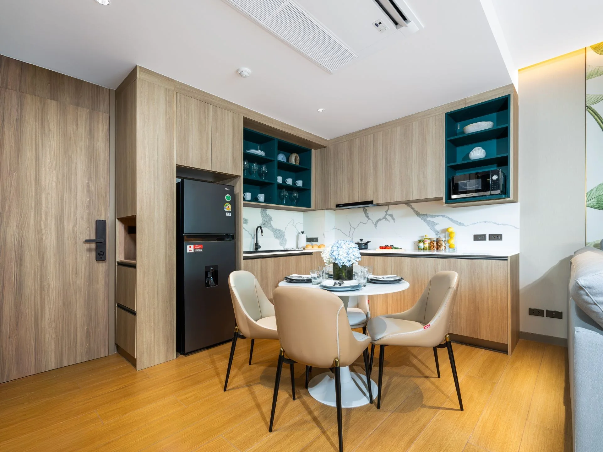 Kitchen and dining area interior in 1-bedroom apartment at Laguna Skypark Elara, Bang Tao
