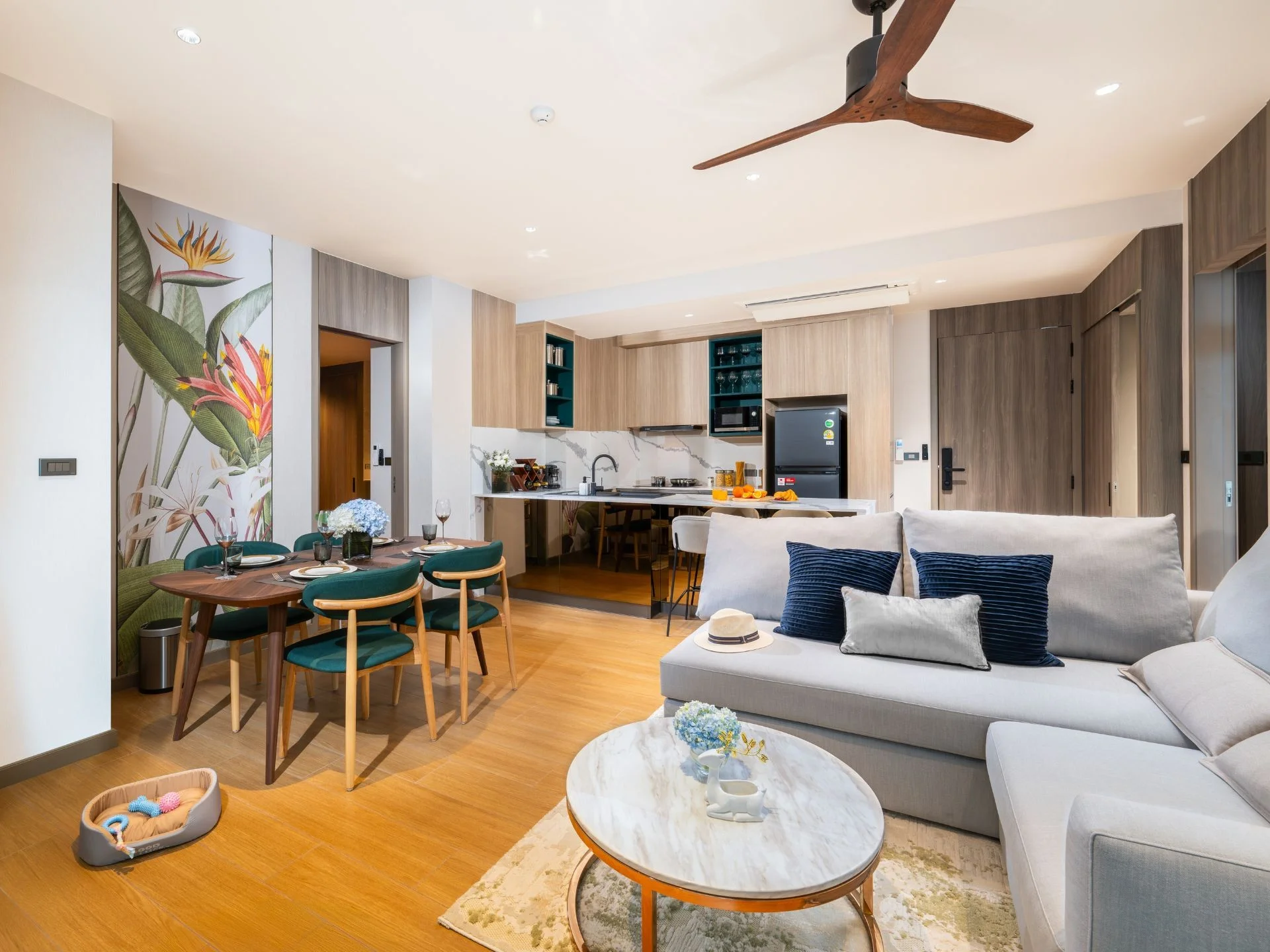 Open-plan living room with kitchen in 2-bedroom apartment at Laguna Skypark Elara, Bang Tao