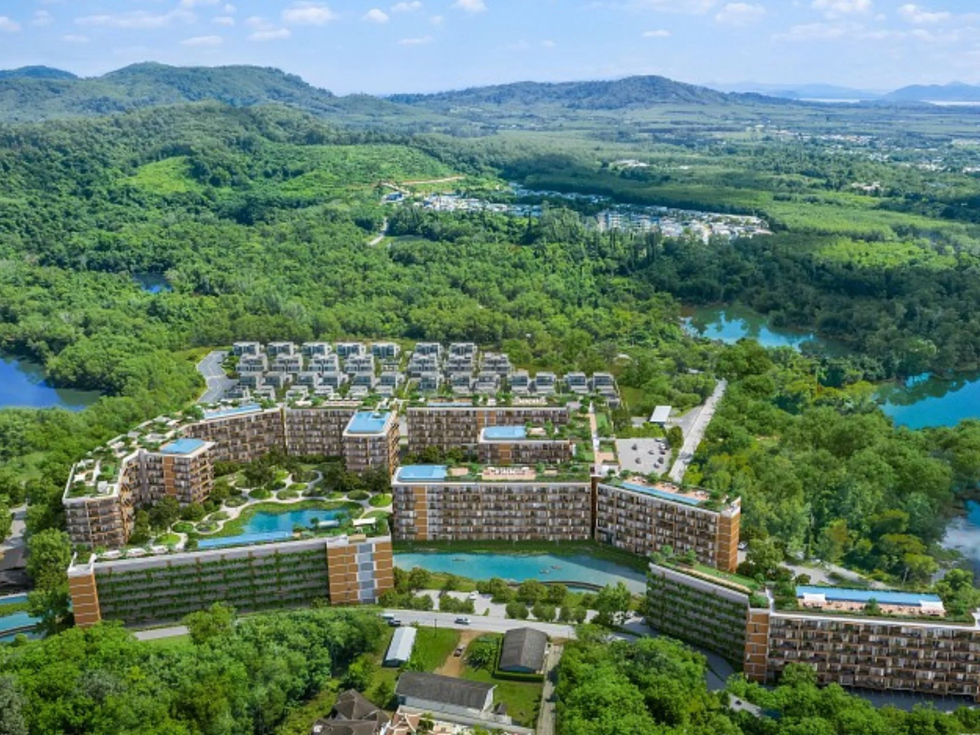 Aerial view of Laguna Skypark Elara residential complex nestled in lush green mountains, Thailand