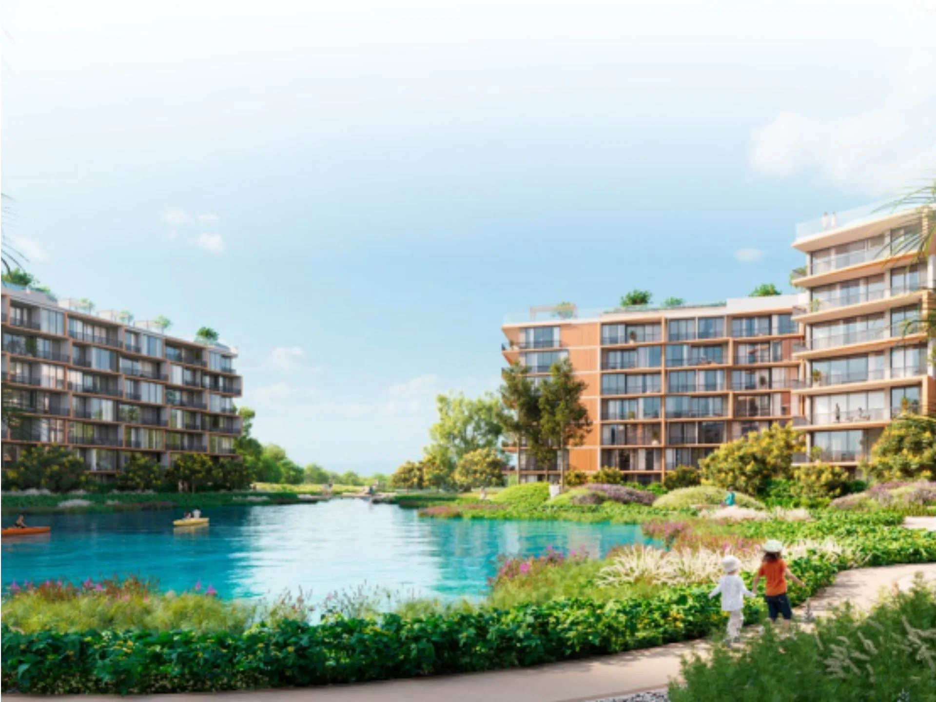 Waterfront landscape with residential buildings and green recreation area at Laguna Skypark Elara, Bang Tao