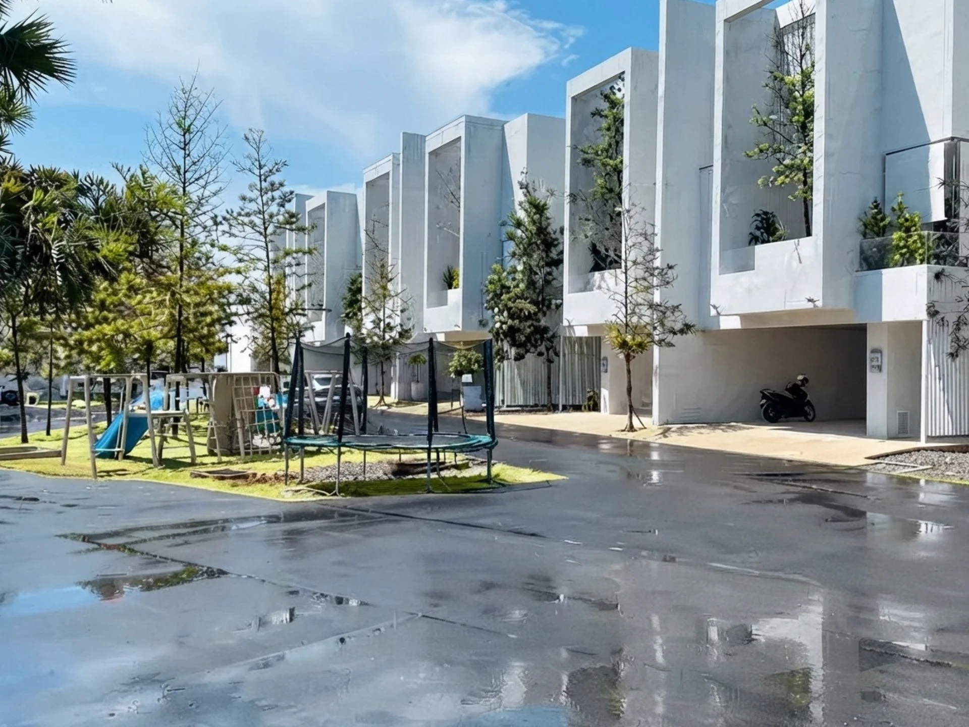 Modern townhouse complex with children's playground and landscaping at The Residence, Bang Tao