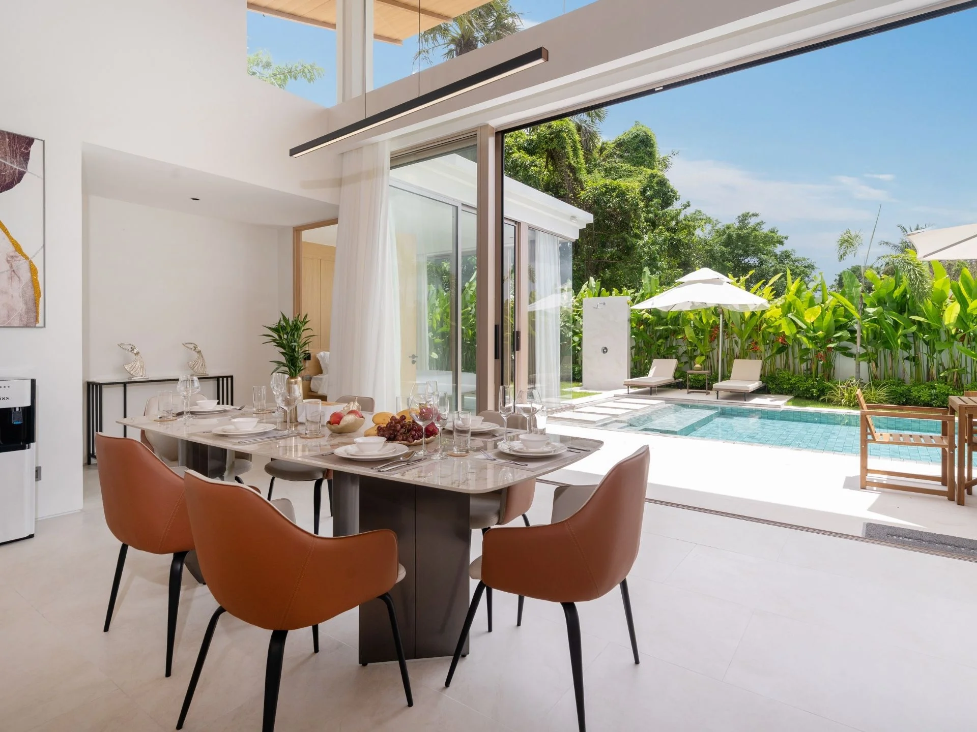 Dining area with pool and garden view in 3-bedroom villa at The Residence, Bang Tao