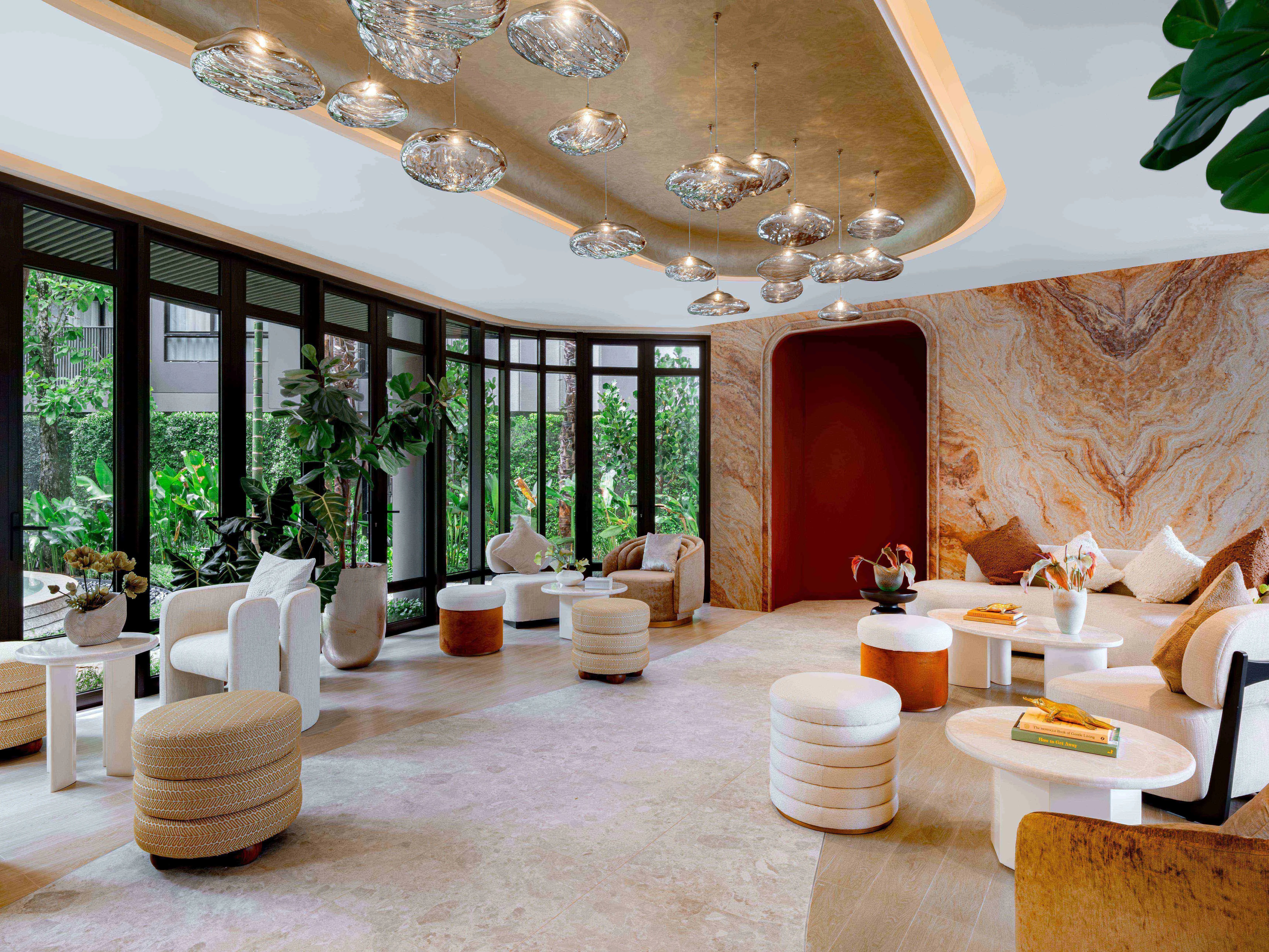 Luxury lounge interior with designer lighting and garden views at The Base Cherngtalay, Thailand