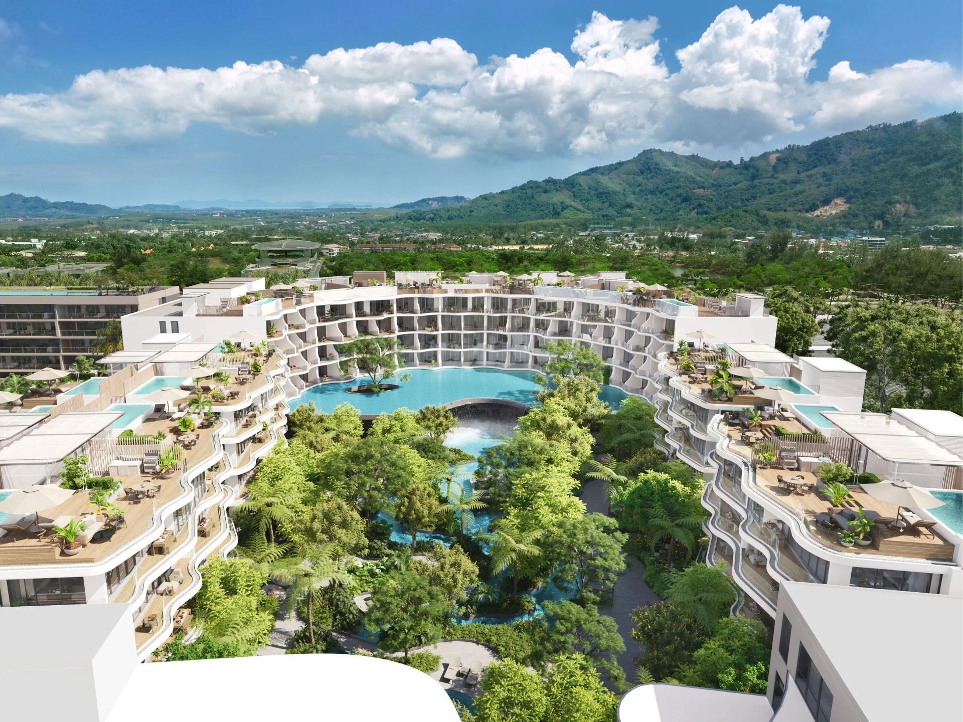 Aerial view of Garrya Residences Phuket with curved architecture, central lagoon pool, and mountain backdrop, Bang Tao
