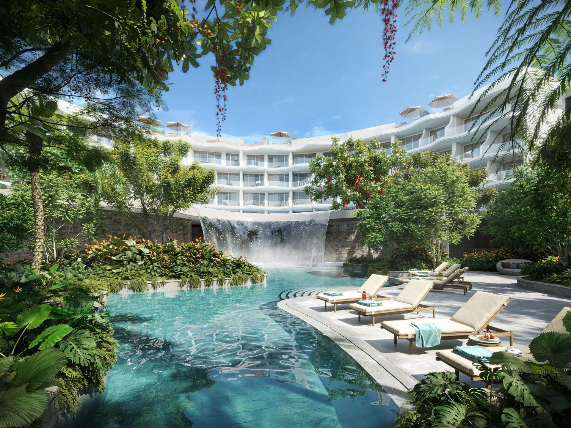 Swimming pool with waterfall feature and lounging area at Garrya Residences Phuket, Bang Tao