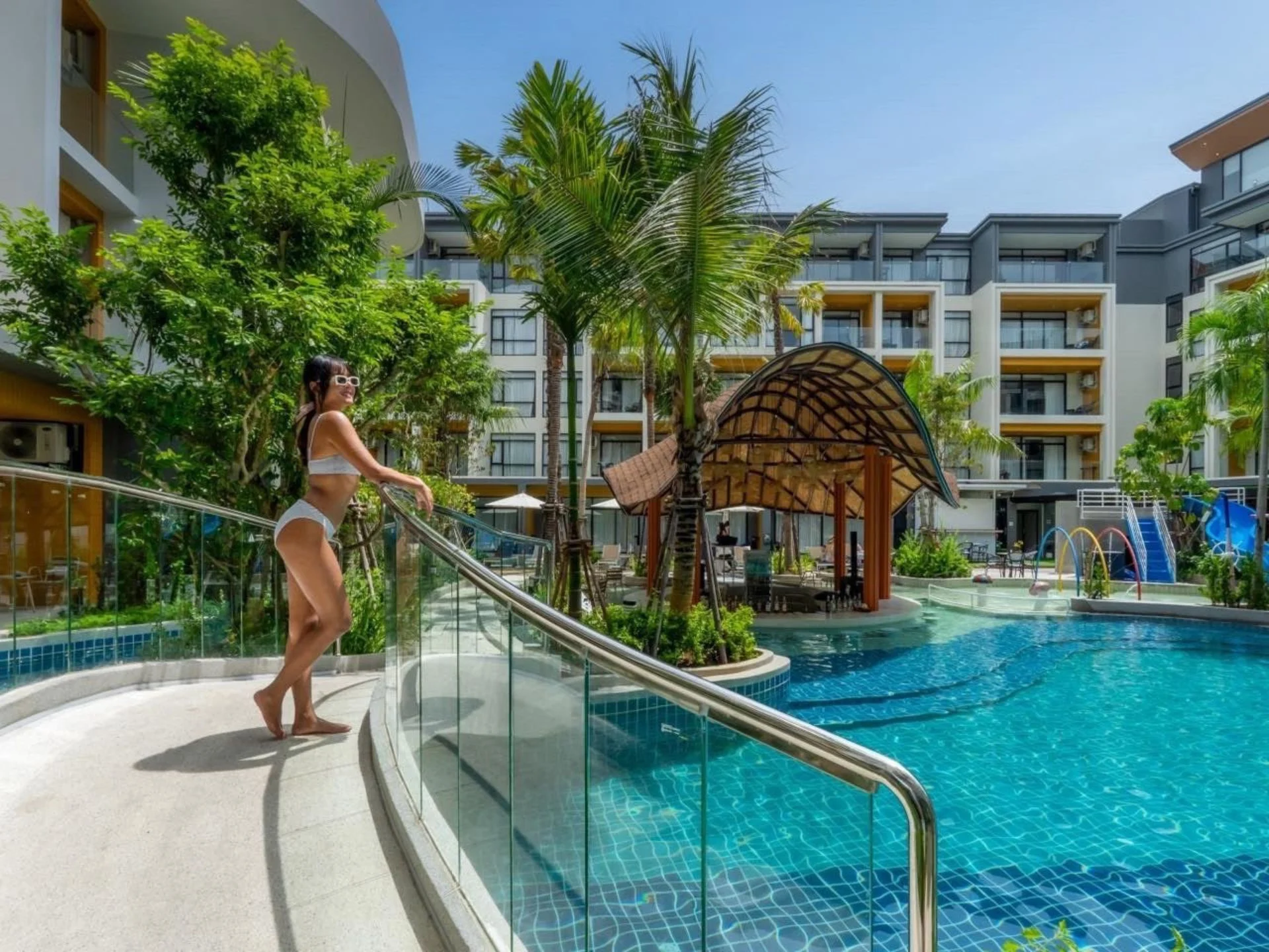 Swimming pool area with tropical landscaping at Sea Heaven Naithon Phase 2, Thailand