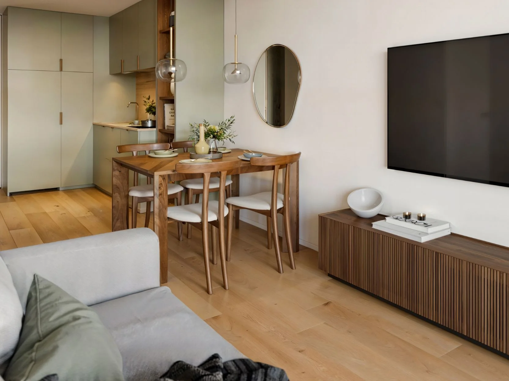 Open-plan living and dining area with kitchen in 1-bedroom apartment at The Momentum Phuket, Laya