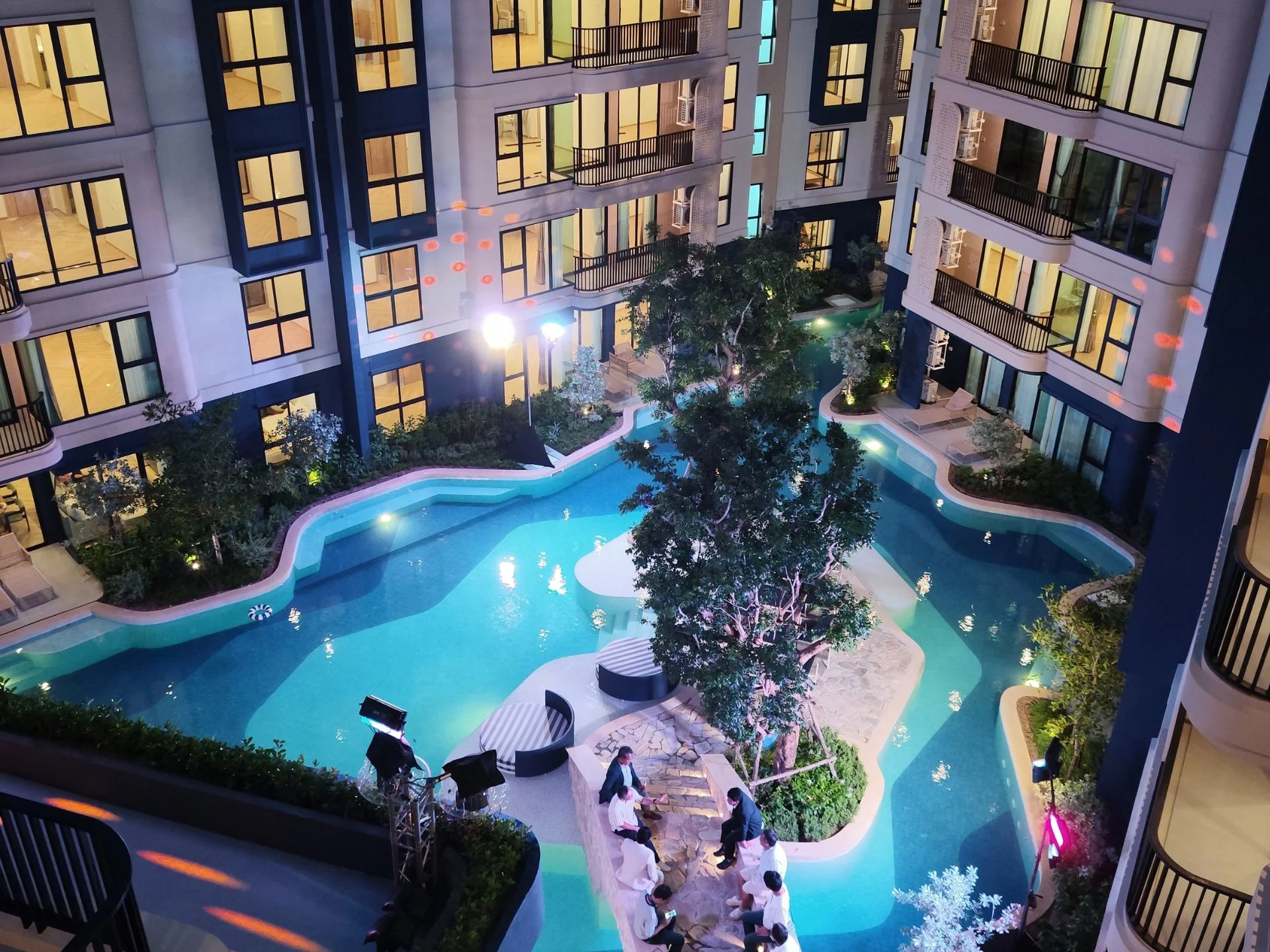 Illuminated swimming pool with landscaping at The Title Cielo, Rawai