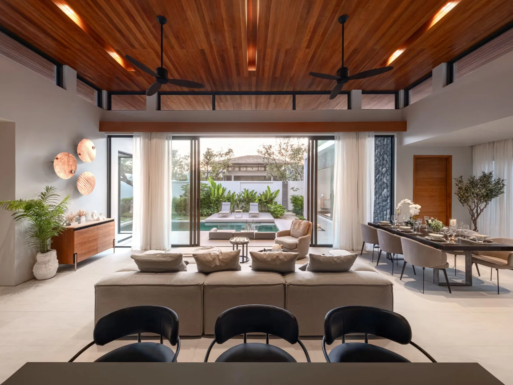 Living room interior with pool view in 3-bedroom villa at Botanica Four Seasons, Laya