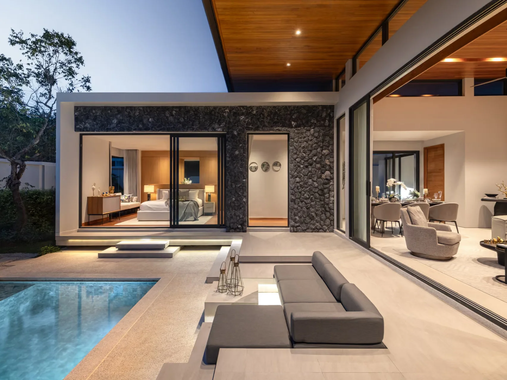 Outdoor terrace with swimming pool and modern villa interior at Botanica Four Seasons, Thailand