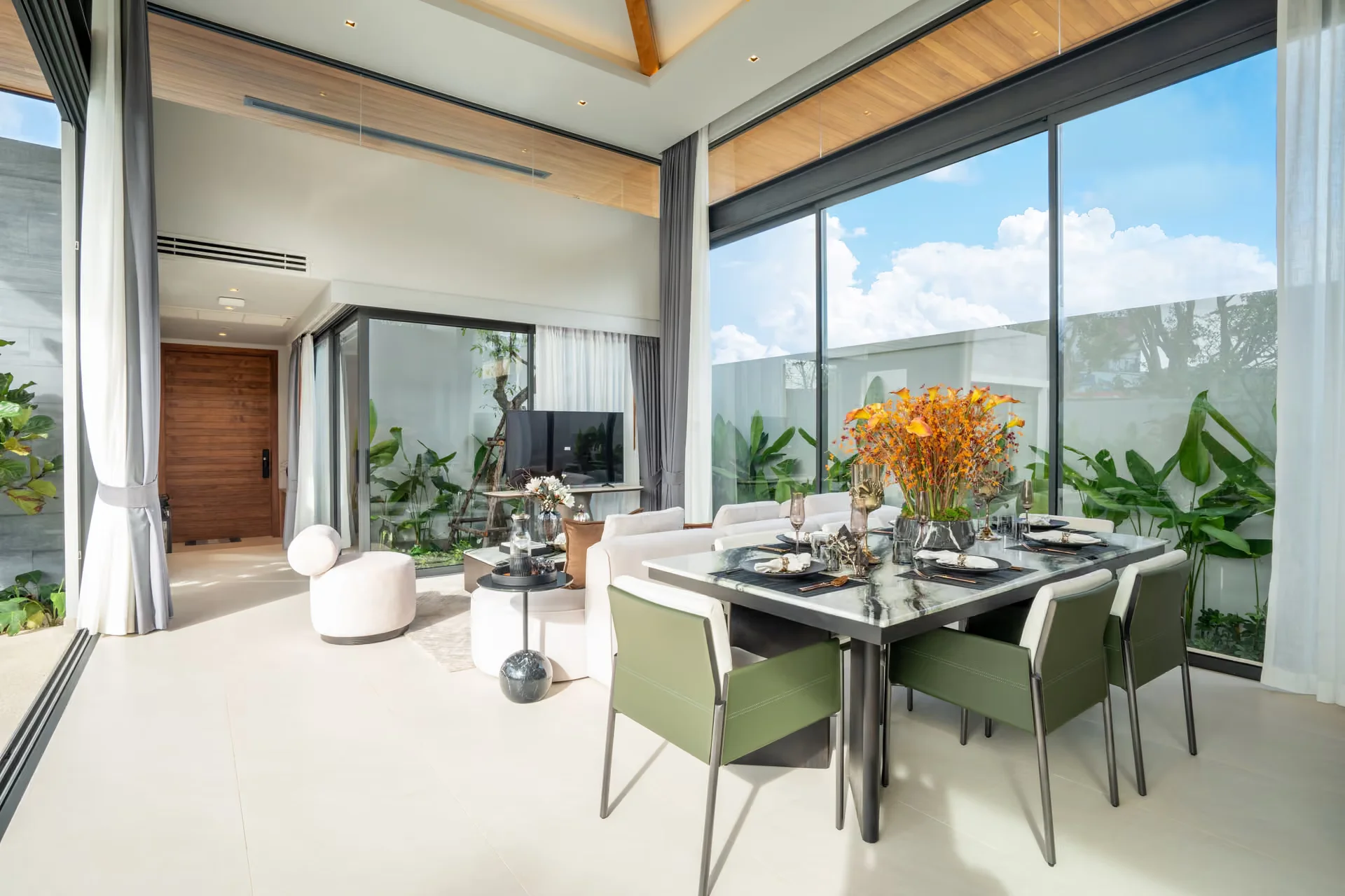 Open-plan living and dining area with garden view in 3-bedroom villa at Botanica Pru Jampa, Talanng
