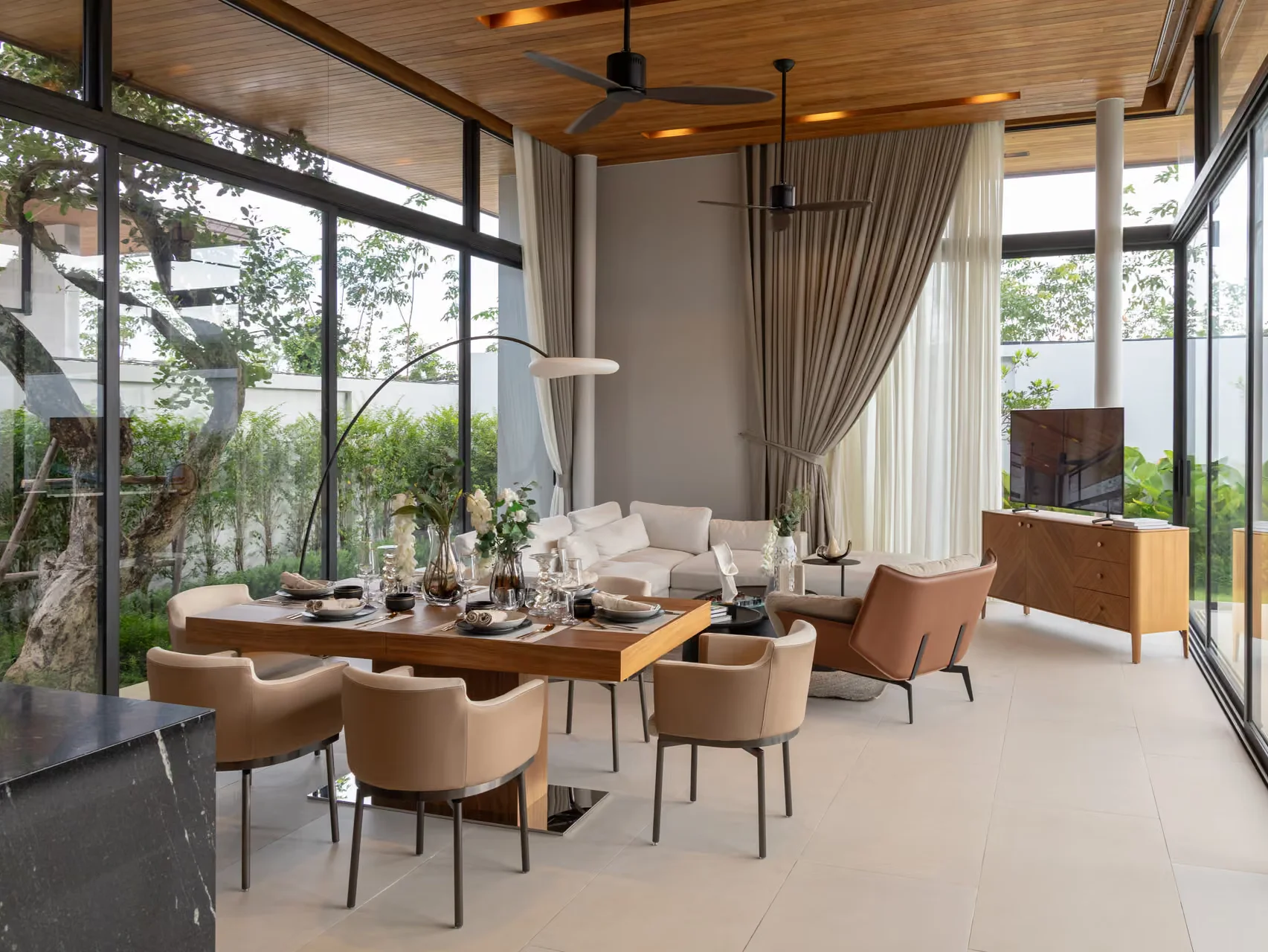 Open-plan living and dining area with garden views in a 4-bedroom villa at Botanica Four Seasons, Laya