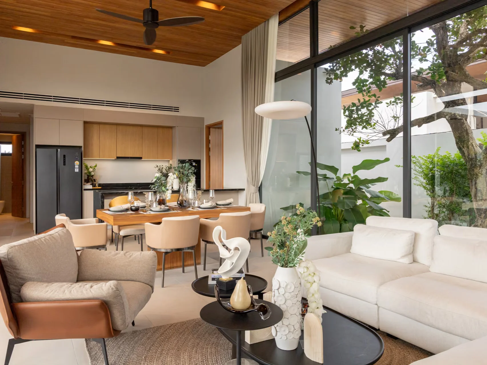 Open-plan living and dining area with kitchen in a 4-bedroom villa at Botanica Four Seasons, Laya