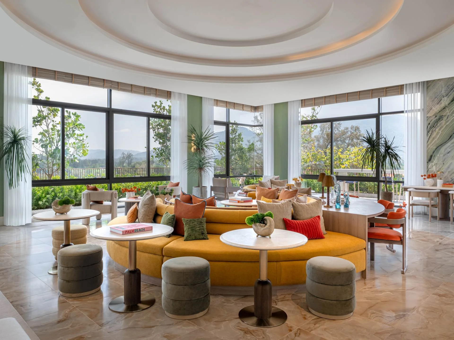 Spacious lounge with curved ceiling, panoramic windows and mountain views at Canvas Cherngtalay, Thailand