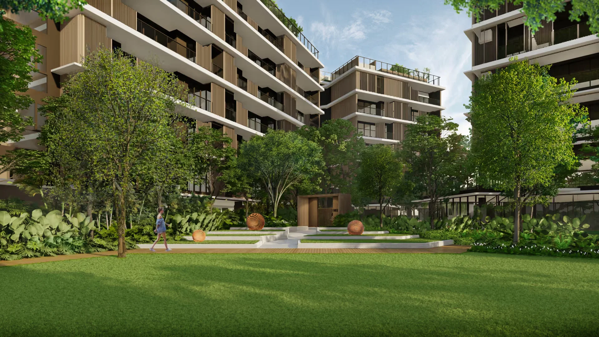 Landscaped courtyard with lawn and mature trees at Laguna Lake Residences Aster, Bang Tao