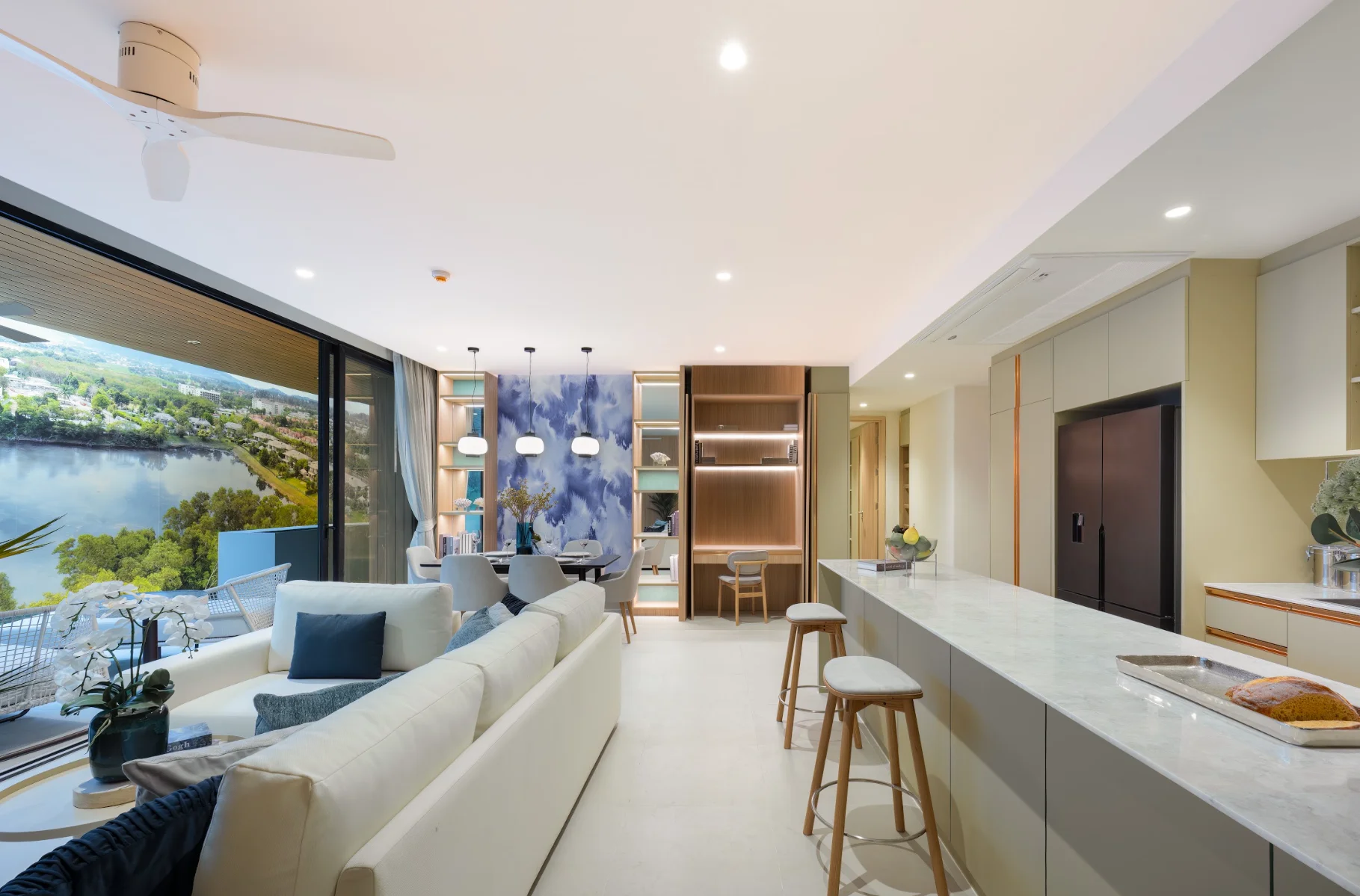 Living room and open kitchen interior in a 2-bedroom apartment at Laguna Lakelands Waterside Residences, Thailand