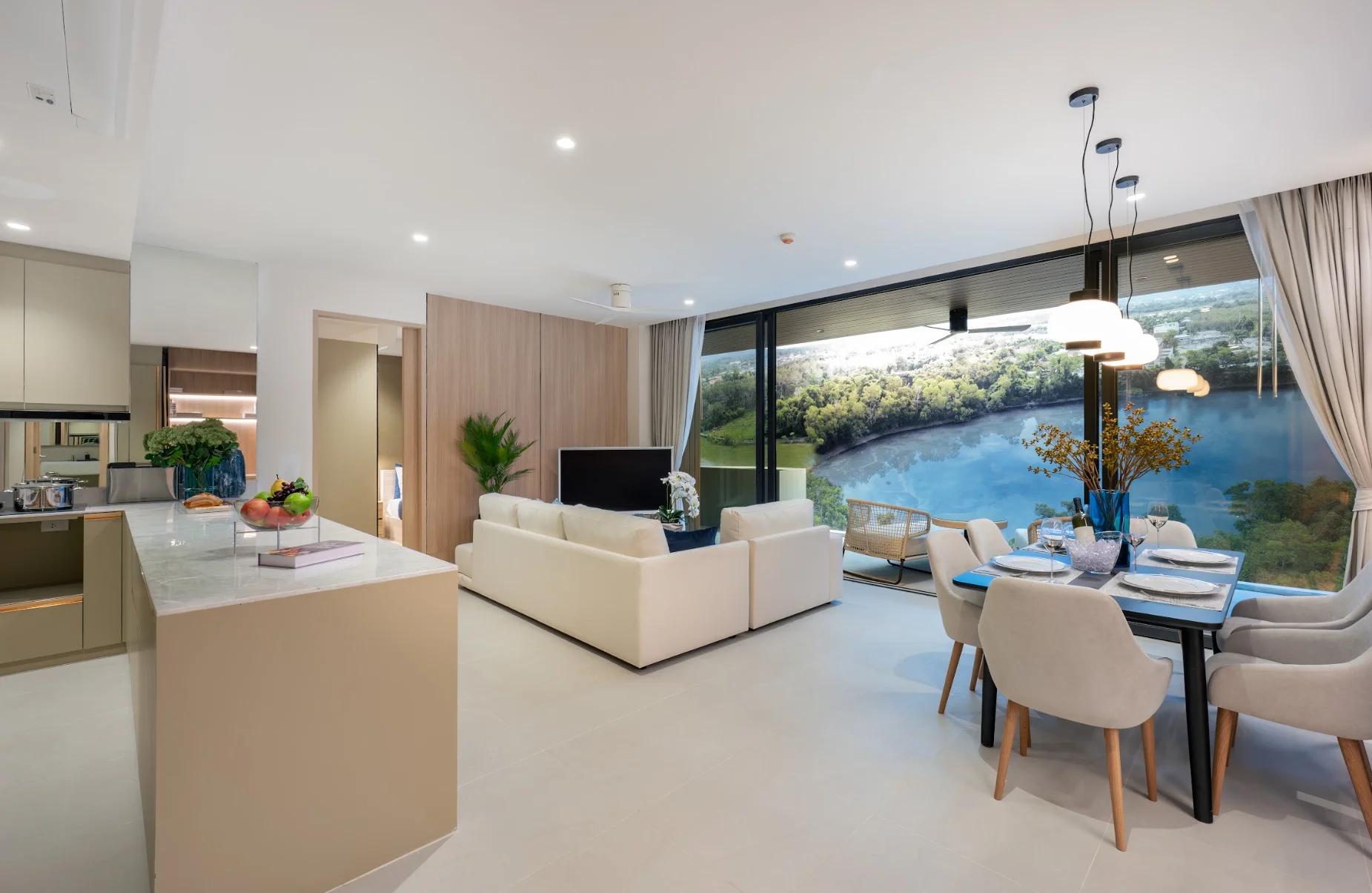 Living and dining area with lake view in a 2-bedroom apartment at Laguna Lakelands Waterside Residences, Laguna, Thailand