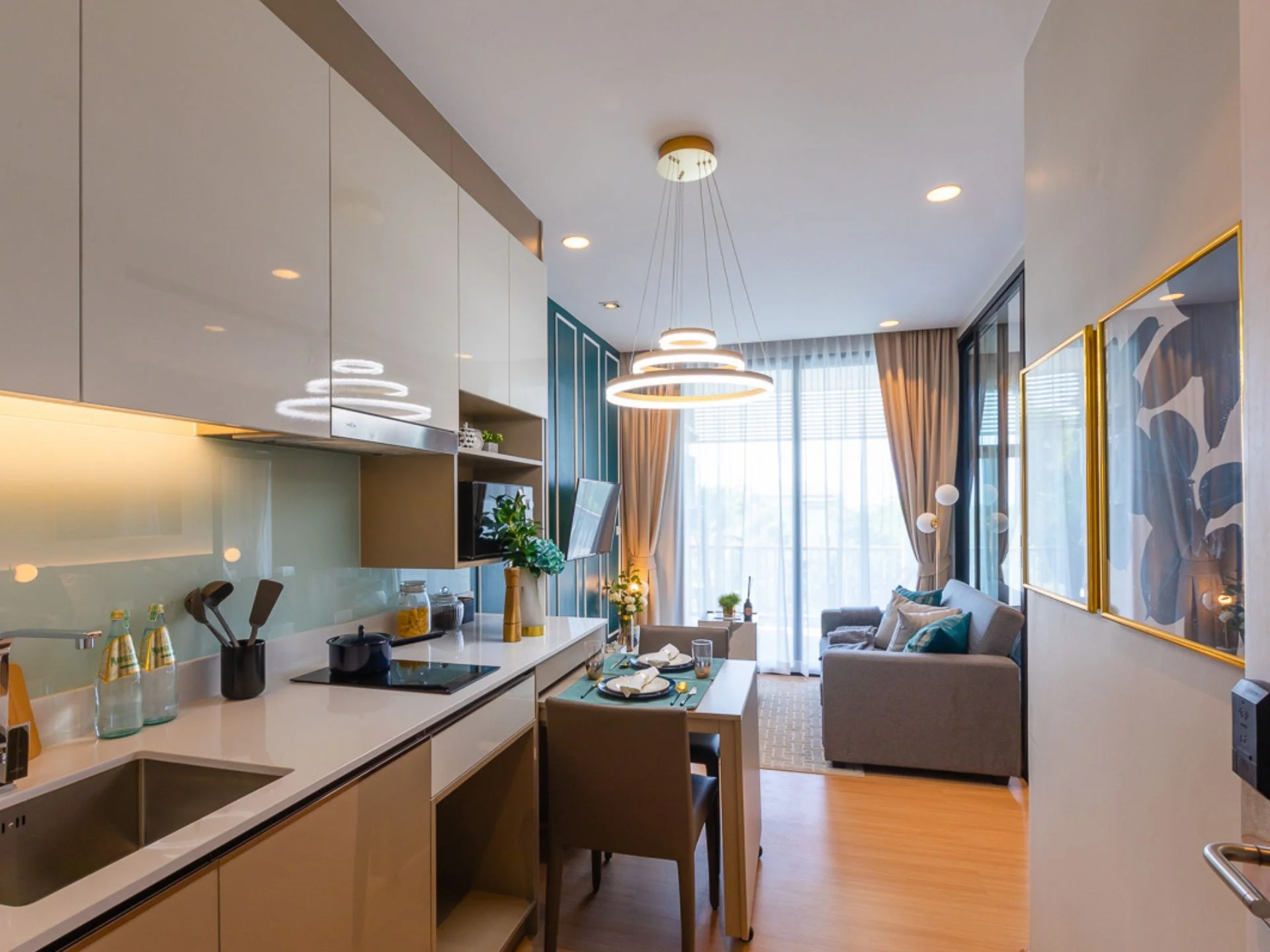 Kitchen and living room interior in a 1-bedroom apartment at Palmetto Park, Karon, Thailand