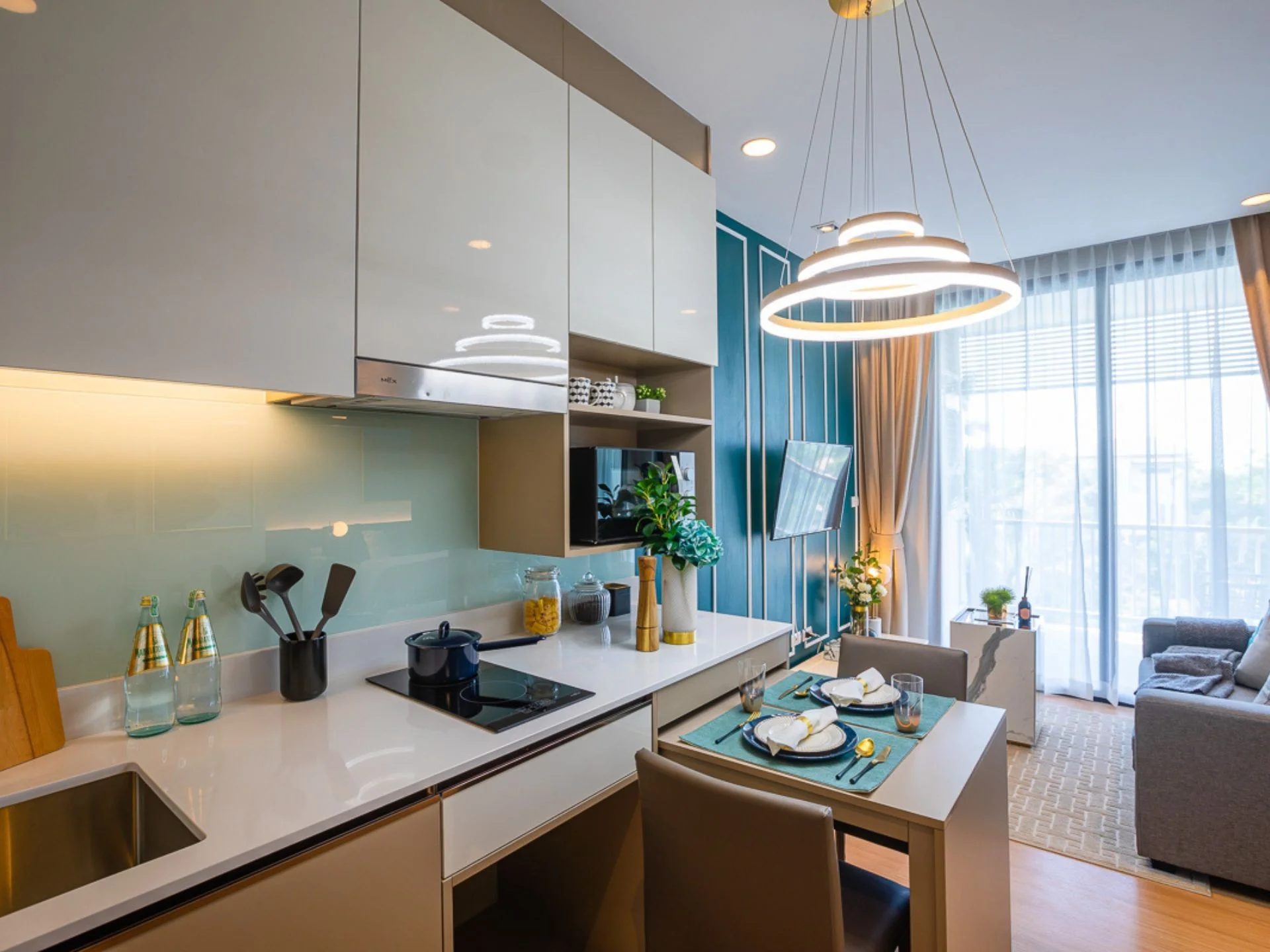 Open-plan kitchen and living room interior in a 1-bedroom apartment at Palmetto Park, Karon, Thailand