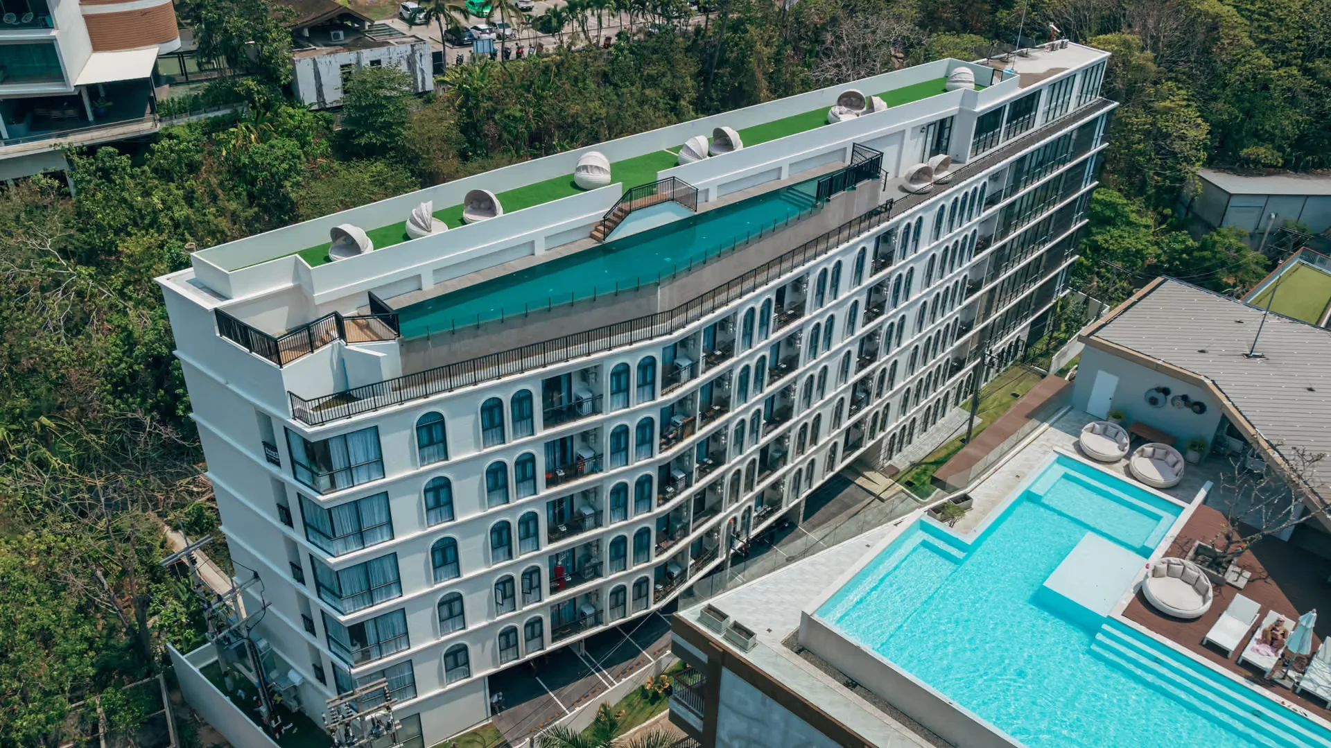 Aerial view of Palmetto Park building facade with rooftop pool and lounge area, Karon, Thailand