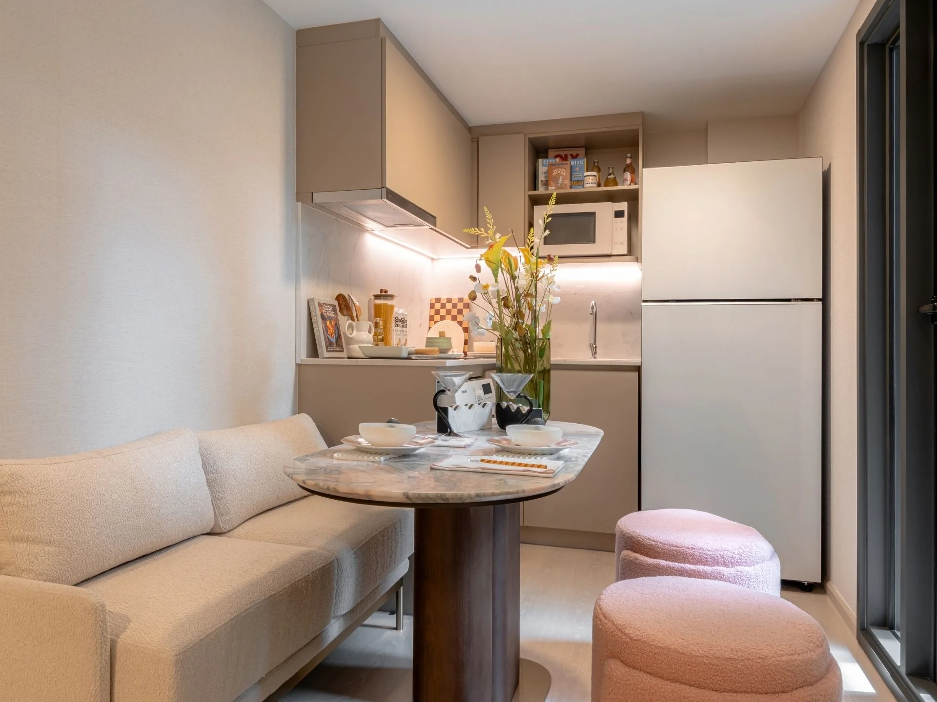 Living room and kitchenette interior in a studio apartment at XELF by Sansiri, Klongtoei, Thailand