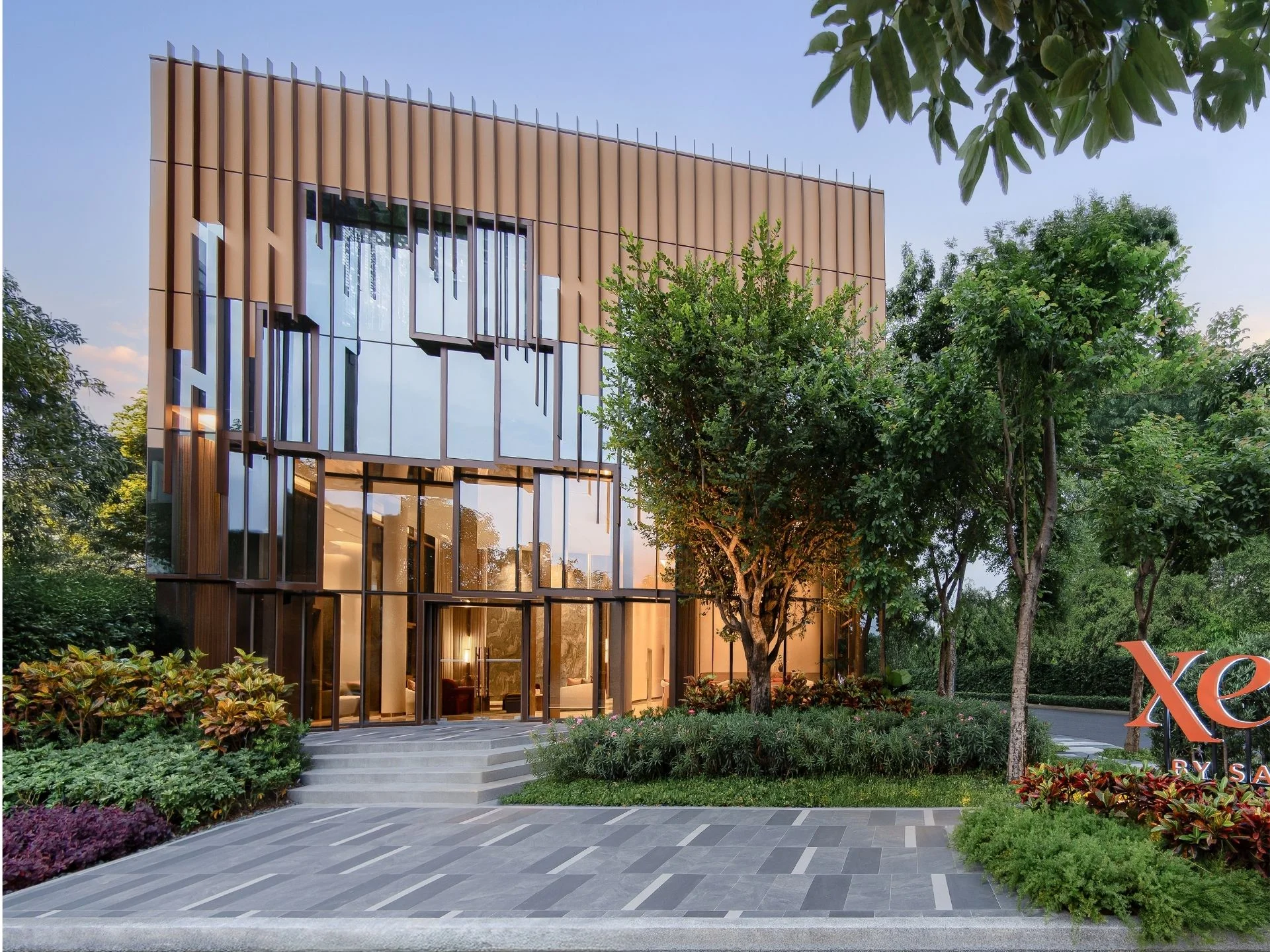 Architecture of XELF by Sansiri building with bronze fins and glass facade, Klongtoey, Thailand