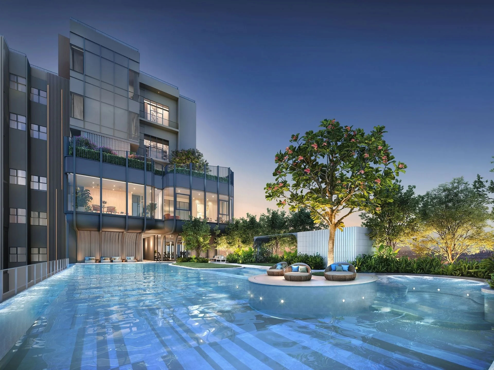 Swimming pool area at XELF by Sansiri, Klong Tan, Thailand, with lounge seating and illuminated evening view