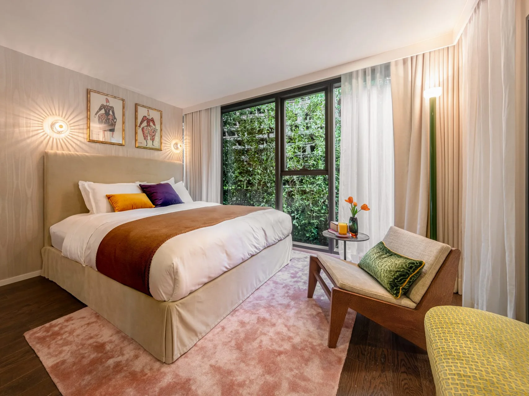 Bedroom interior in a 2-bedroom apartment at SHUSH Ratchathewi, Thailand, with green vertical garden view