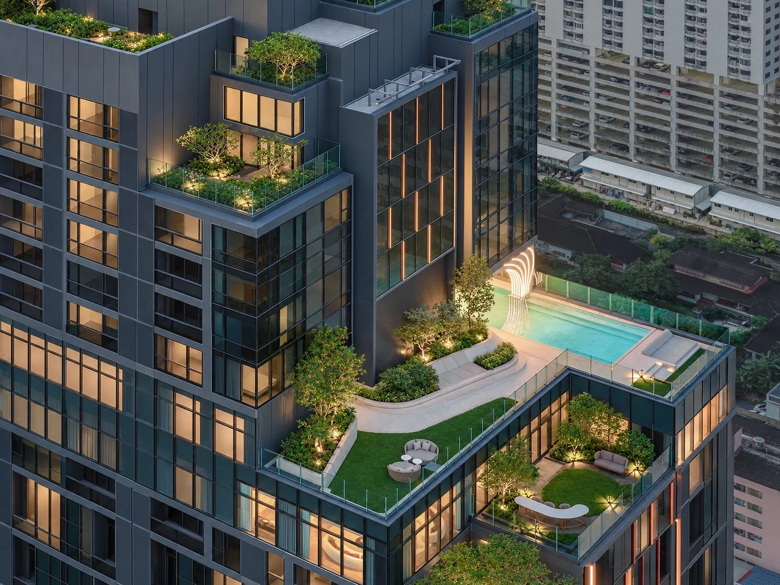 Rooftop swimming pool and landscaped terraces at SHUSH Ratchathewi, Thailand, aerial dusk view