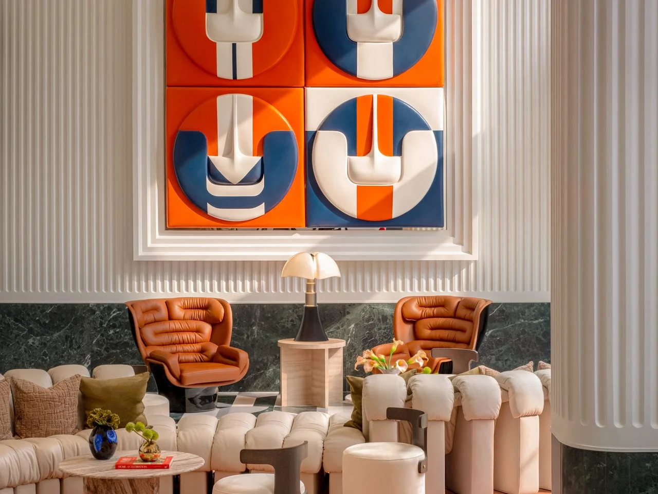 Lobby lounge interior with orange and blue wall panels and cream sofas at SHUSH Ratchathewi, Thailand