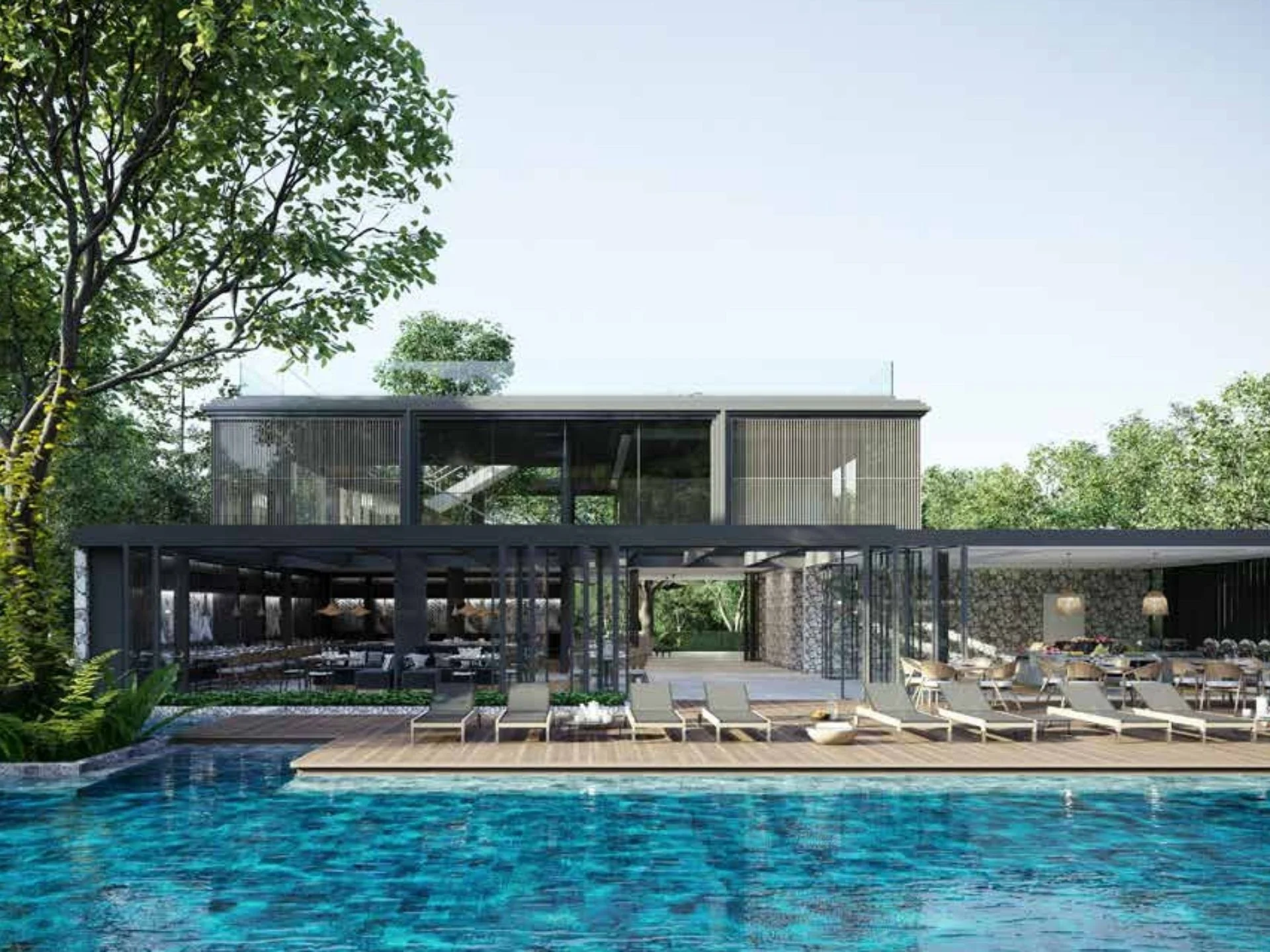 Swimming pool area with lounge deck and clubhouse at MGallery Residences MontAzure, Kamala, Thailand