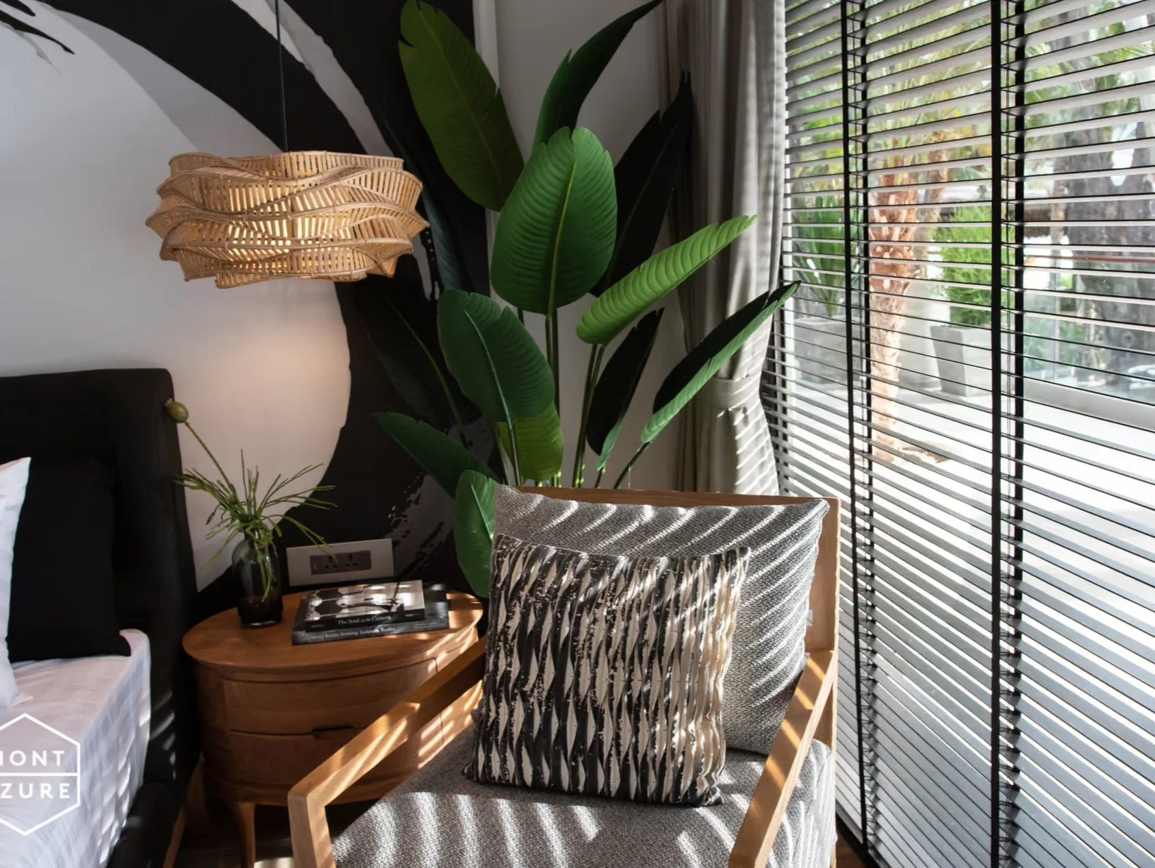 Reading corner with armchair and window blinds in a studio at MGallery Residences MontAzure, Kamala, Thailand