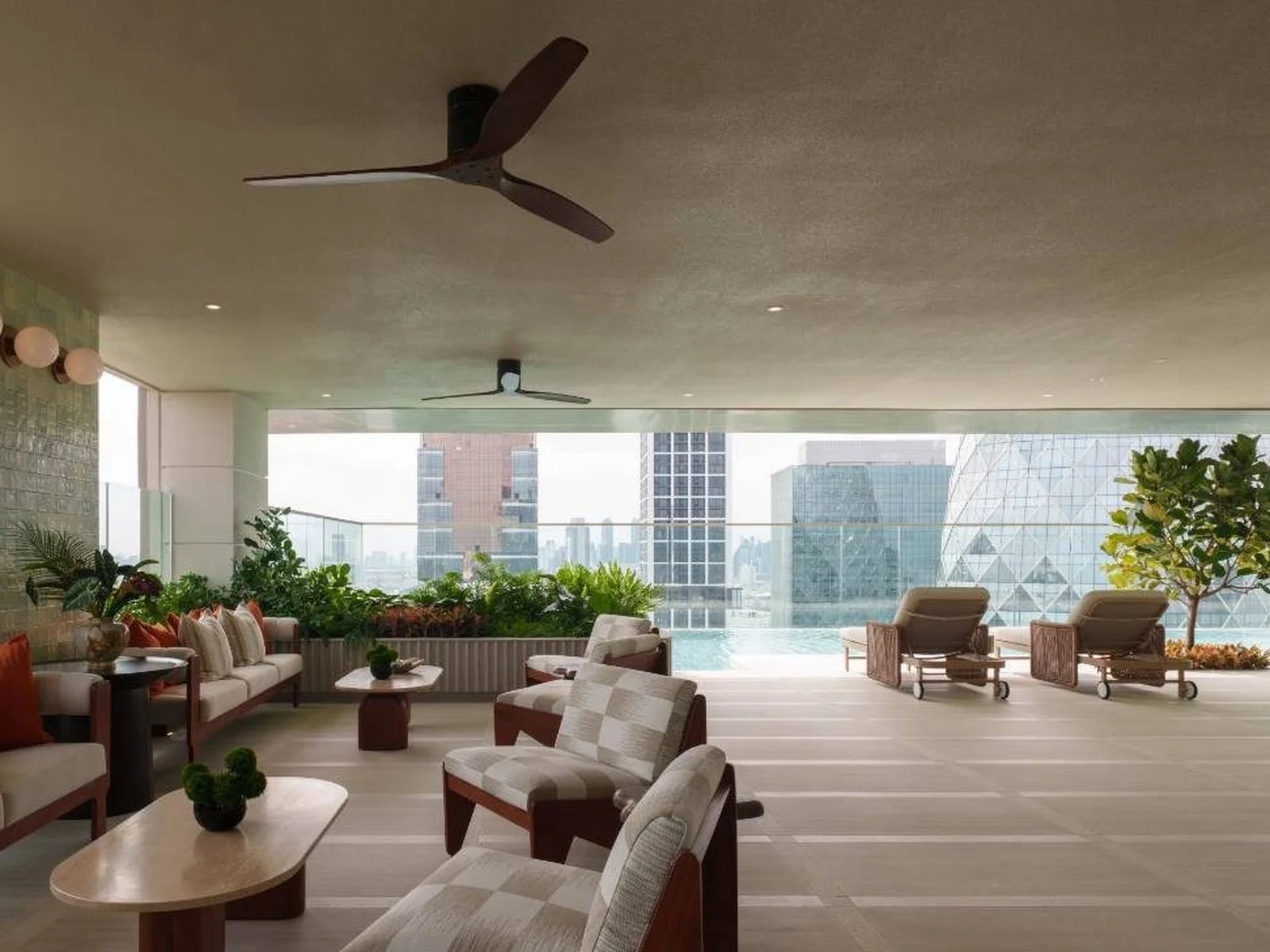 Rooftop pool deck lounge with seating areas and city view at Via Ari residence, Ari, Thailand