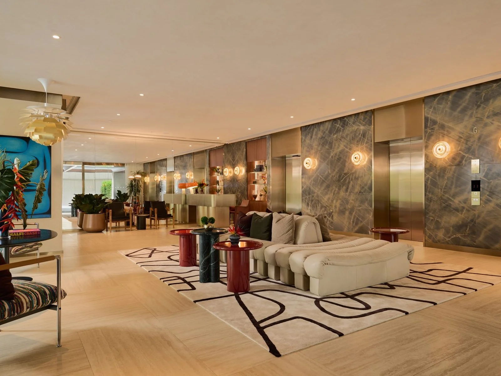 Lobby lounge with elevators and marble walls at Via Ari, Thailand