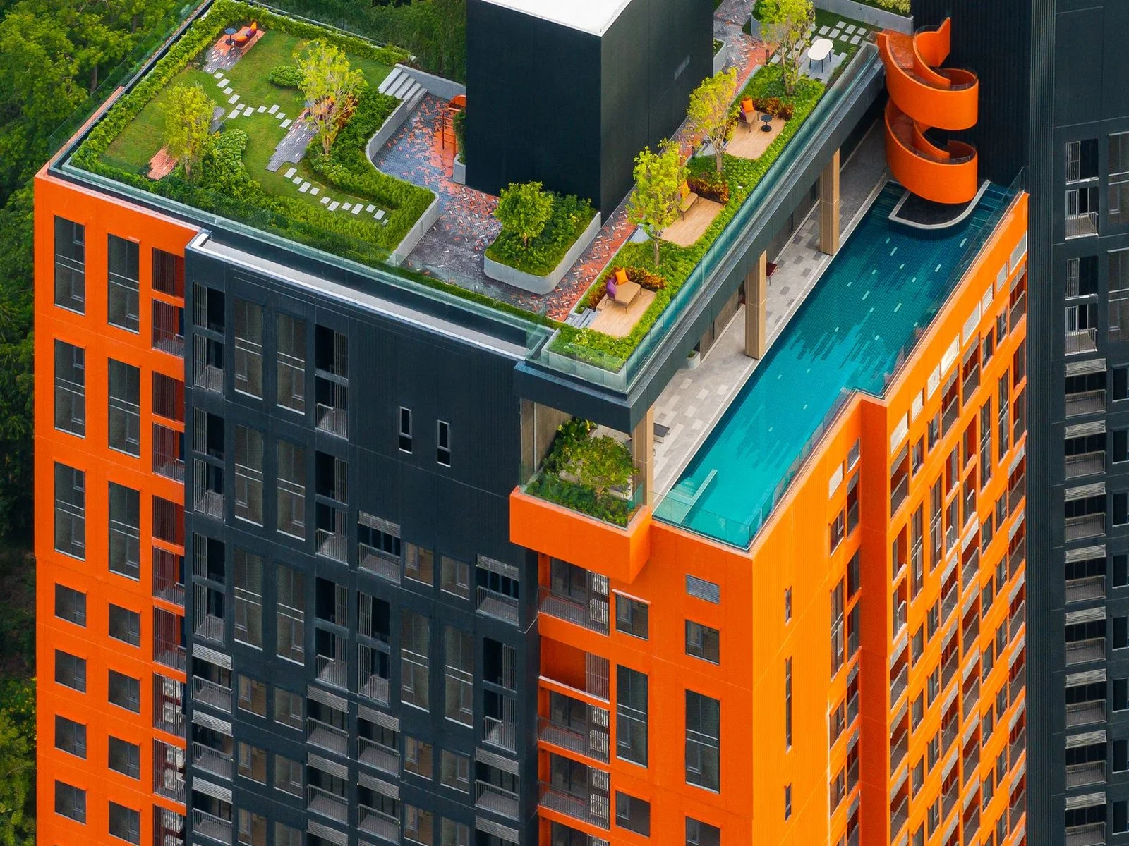 Aerial view of FLO by Sansiri rooftop infinity pool and landscaped garden terrace, Khlong San, Thailand