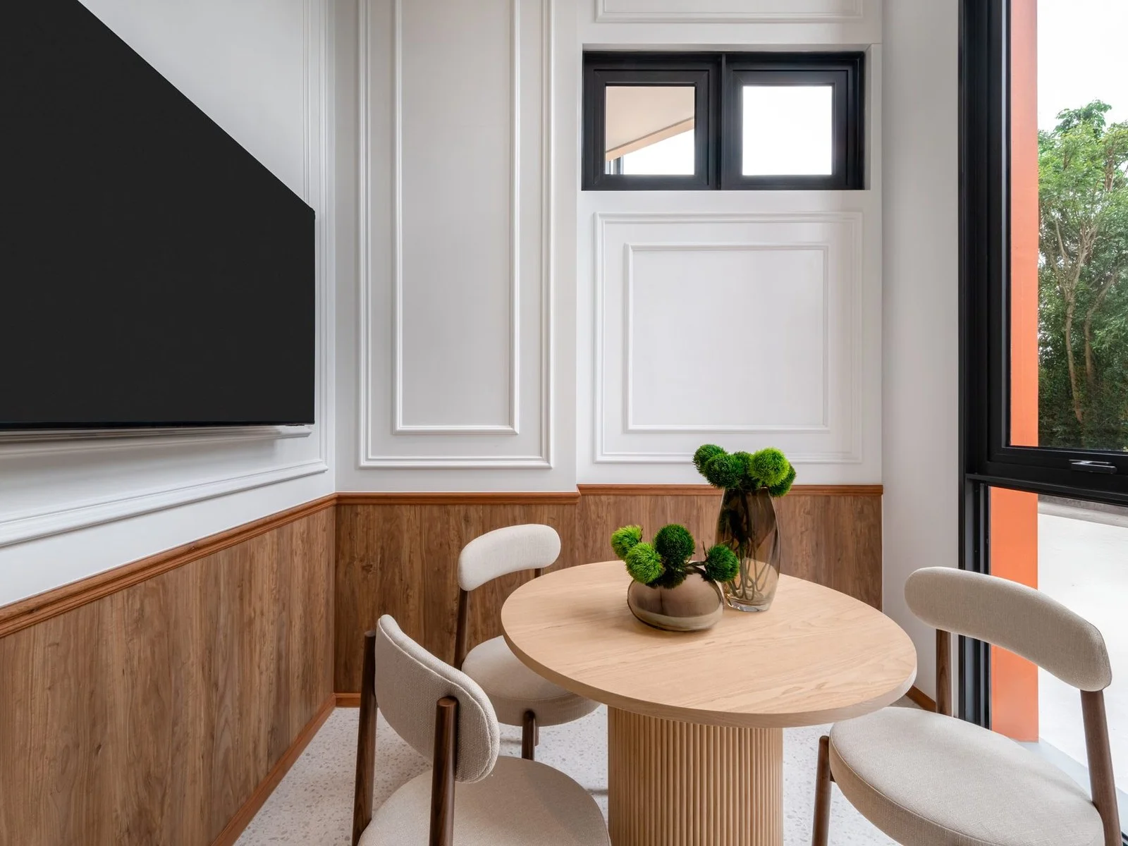 Dining area interior with round wood table and upholstered chairs in a 2-bedroom apartment at FLO by Sansiri, Khlong San, ...