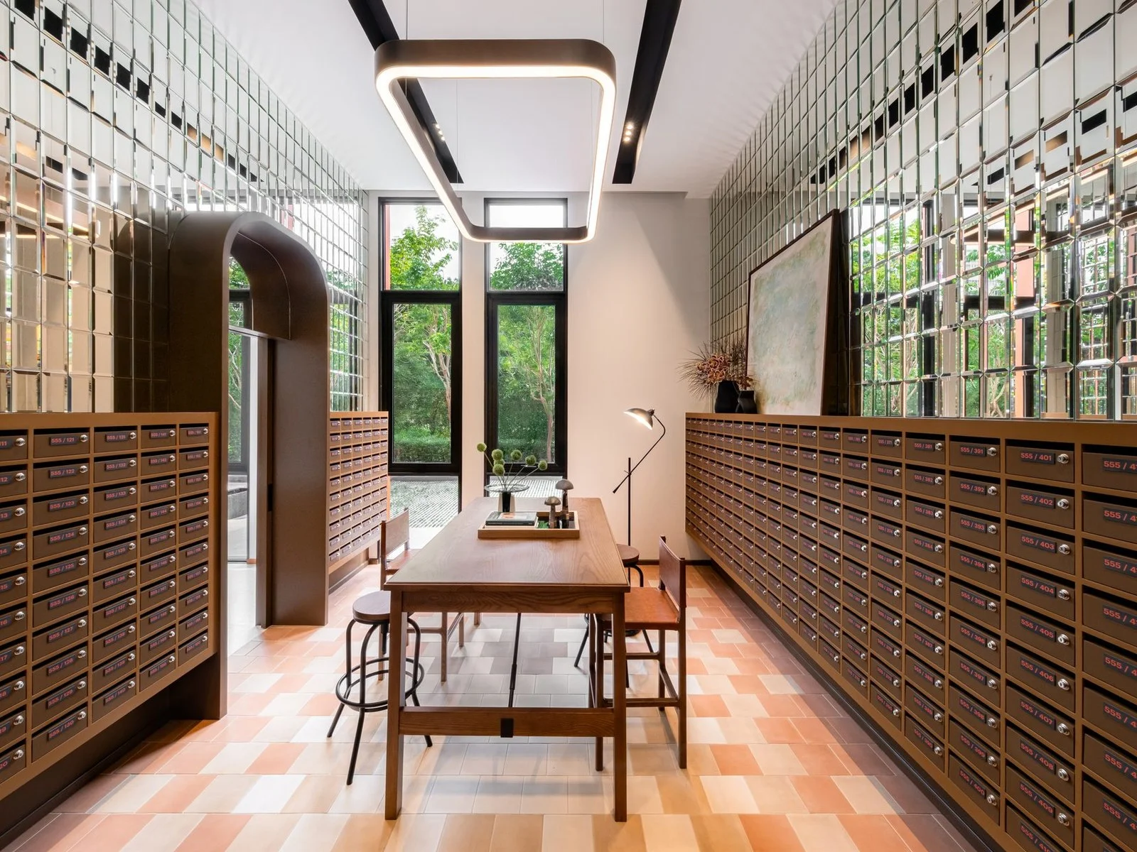 Mailroom lobby with wall-mounted mailboxes and wooden table at FLO by Sansiri, Khlong San, Thailand