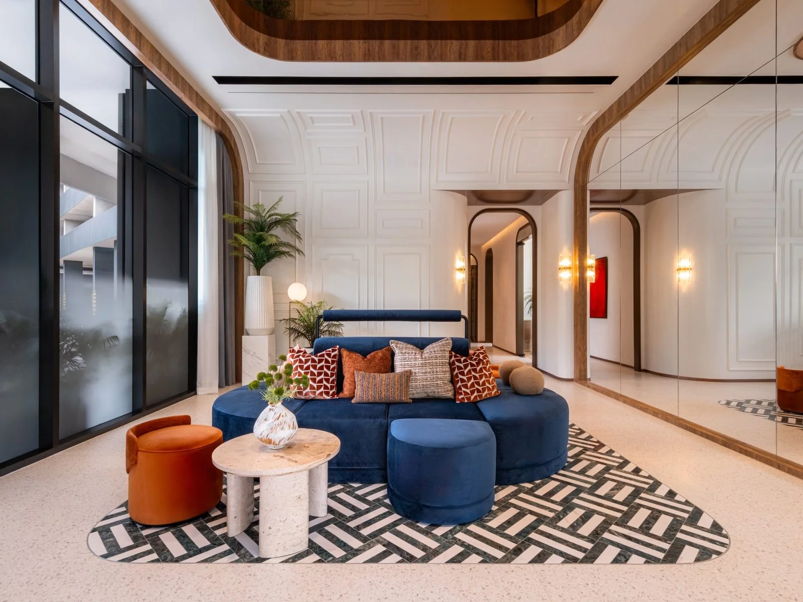 Lobby lounge with blue velvet sofa and mirrored wall at FLO by Sansiri, Khlong San, Thailand