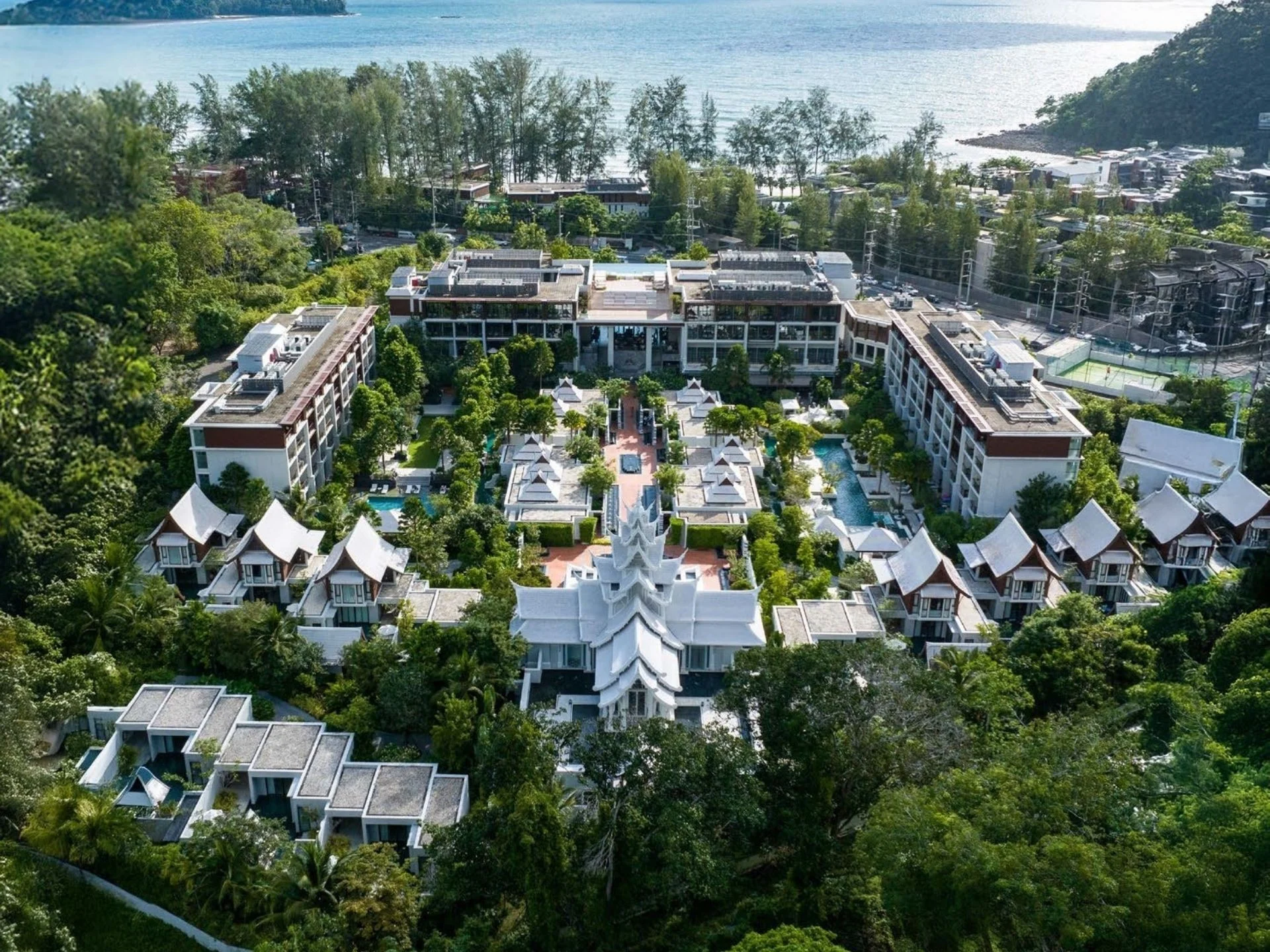 Aerial view of The Residences at InterContinental Phuket Resort complex, Thailand, with tropical gardens and sea in backgr...